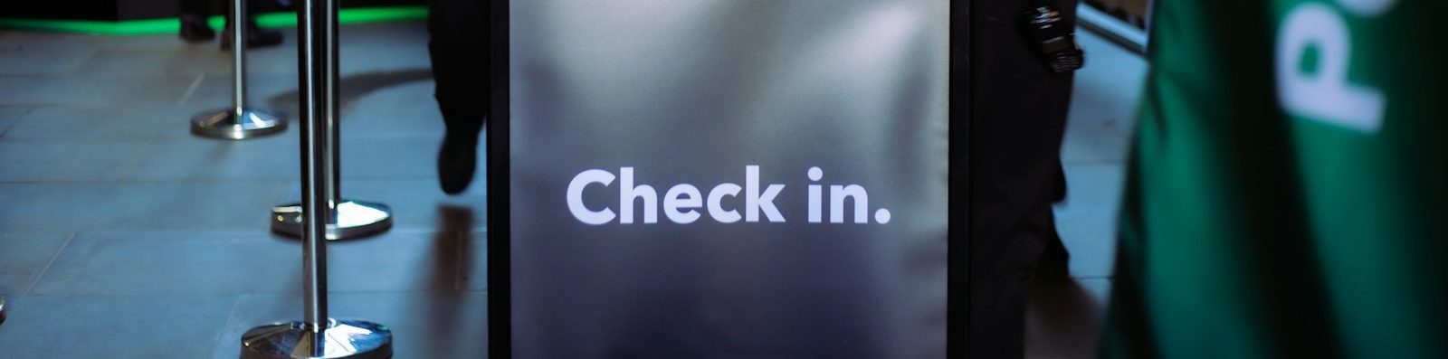 a group of people standing around a check in counter